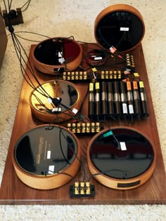 an array of electronic equipment sitting on top of a wooden table