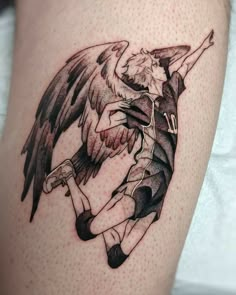 an artistic tattoo on the leg of a man with wings and a woman holding her head