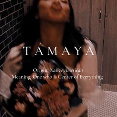 a woman standing in front of a brick wall with her mouth open and the words tamaya on it