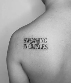 a black and white photo of a man's shoulder with the words swimming in circles on it