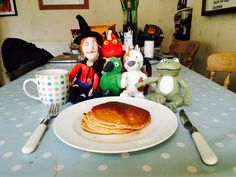 pancakes and stuffed animals sit on a table