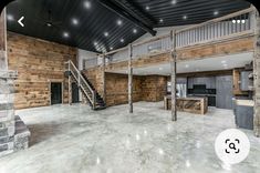 an empty room with wooden walls and stairs