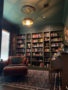 a living room filled with lots of furniture and bookshelves covered in shelves full of books