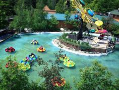 an aerial view of a water park with people on inflatables