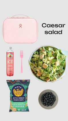 the contents of a lunch box including salad, blueberries, and watermelon