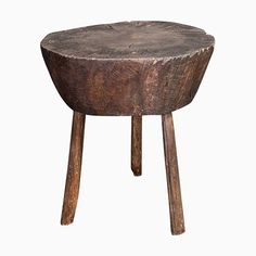 an old wooden stool with two legs and a small table top on one end that has been carved into the shape of a tree stump