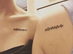 two women with matching tattoos on their chests, one has an arrow and the other says