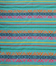 a blue and orange striped fabric with different colored designs on it's sides,