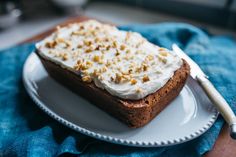 a piece of cake sitting on top of a white plate next to a blue towel