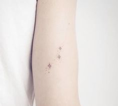 a person with a small star tattoo on their arm