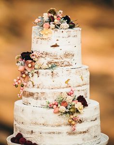 a white wedding cake with flowers on top