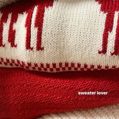 two red and white knitted sweaters laying on top of each other with the words, sweater lover written across them