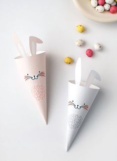 two paper cones with bunny ears on them