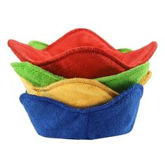 four different colored dishcloths stacked in a blue bowl on top of each other