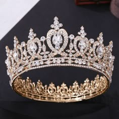 a gold tiara with white and clear stones