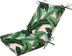 an outdoor chair cushion with green leaves on it