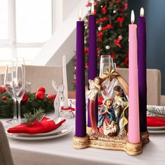 a christmas table setting with candles and decorations