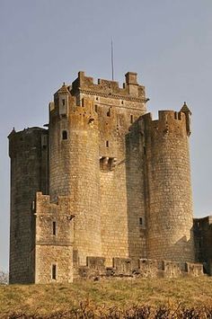 an old castle sitting on top of a hill