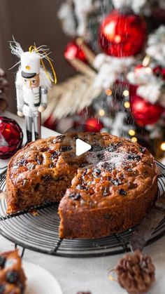 a cake on a cooling rack next to christmas decorations