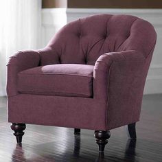 a purple chair sitting on top of a hard wood floor