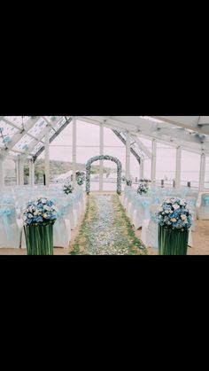 an outdoor wedding venue set up with blue and white flowers