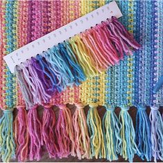 crochet fringes are laid out on a table with a ruler in the middle