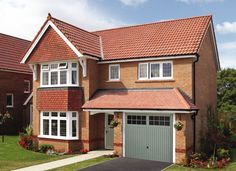 a two story brick house with white windows and red tile roofing on a sunny day