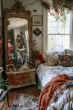 a bed sitting under a window next to a dresser with a mirror on top of it