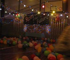 there are many balloons and lights in the room