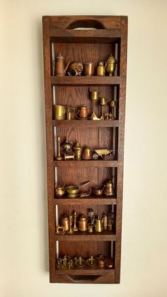 a wooden shelf filled with lots of different types of pots and pans on top of it