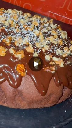 a cake with chocolate frosting and nuts on top