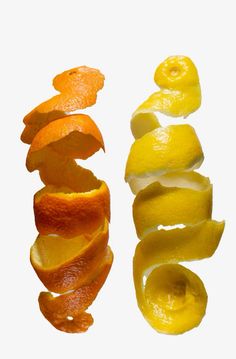 peeled oranges and peels on a white background with one sliced in half to show the insides