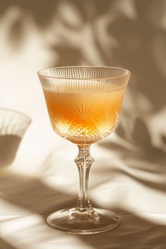 a glass filled with liquid sitting on top of a table