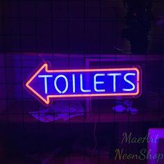 a neon sign that says toilets on it