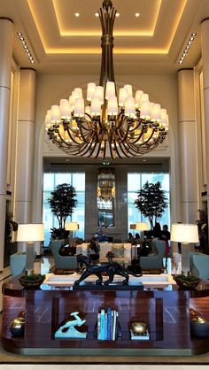 a large chandelier hanging from the ceiling in a living room