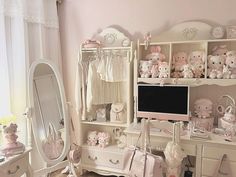 a room filled with lots of white furniture and teddy bears on top of the shelves