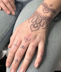 a woman's hand with tattoos on it