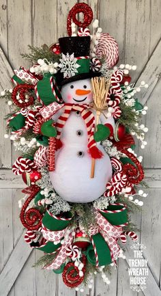 a christmas wreath with a snowman and candy canes