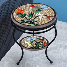 a mosaic side table with flowers on it