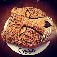 a cake made to look like a cheetah's head on a plate