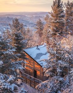 a cabin in the woods covered in snow