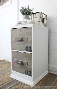 a white cabinet with two drawers sitting on top of it's sides next to a rug