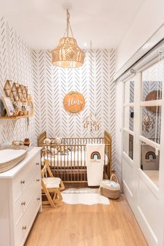 a baby's room is decorated in white and gold