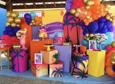 an assortment of colorful balloons and gifts on display at a party or event with palm trees