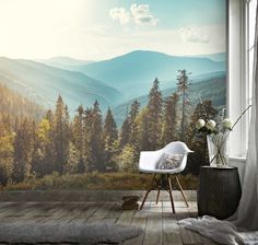 a chair sitting in front of a window on top of a wooden floor next to a forest