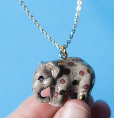 Join the merry parade and experience the magic of wonder with our delightful pink polka dot elephant necklace! 🐘💕 This enchanting accessory features a playful elephant charm, adorned with a glossy pink polka dot pattern, hanging from a delicate gold-tone chain. It's a whimsical piece that will transport you to a dreamy world of playful imagination.🥇 Crafted from fine porcelain👩‍🎨 Meticulously hand painted in detail🌳 Heirloom quality✔️ Highly collectible🔗 Gold steel clasp💝 Individually gi Puzzle Decor, Candle Stick Decor, Elephant Jewelry, Glossier Pink, Elephant Necklace, Baby Album, Elephant Charm, Childrens Gifts, Toddler Boy Outfits