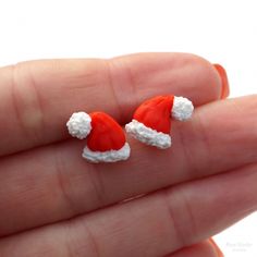 Santa Hat Stud Earrings. The size of a hat is about 13x11 mm (0.5x0.4 inch) Other earrings you can see here: https://www.etsy.com/shop/RinaStudioDesign?section_id=24005662 * Submersion in water is not recommended for polymer clay as this will quickly deteriorate the product. It is recommended that you remove the earrings prior to swimming or showering to extend the life of the product. * Due to the handmade quality of all products, each one will vary slightly in appearance. While I do my very best to make them as similar as possible exact replication is not possible. * All items are packaged in a gift boxes to avoid any damage during the delivery. To reduce waste and shipping costs, multiple items will be packaged together. If you'd like separate boxes or have other special shipping reques Adjustable Earrings For Christmas Gift, Adjustable Earrings As A Christmas Gift, Novelty Red Earrings For Gift, Cute Red Christmas Earrings, Novelty Red Christmas Jewelry, Red Novelty Christmas Jewelry, Red Christmas Novelty Jewelry, Red Earrings For Christmas Gift, Cute Red Earrings For Christmas