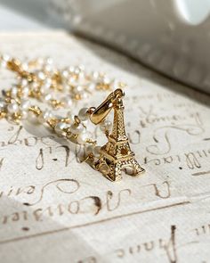 The Bonne Journée Necklace features an elegant Eiffel Tower pendant on a delicate pearl rosary chain. With an adjustable length of 16.5-18 inches, this necklace is perfect for adding a touch of Parisian charm to any outfit.  Eiffel Tower Charm 20mmGold plated silver and fresh water pearls. 16.5-18" adjustable. All items come in a gift box ready to gift. To see more please visit  https://www.etsy.com/shop/BijouLimon Bijou Limon jewelry collections present a romantic French spin on the latest jewe Pearl Rosary, Latest Jewellery Trends, Paris Wedding, Rosary Chain, Fresh Water Pearls, Vermeil Jewelry, Water Pearls, Gift For Girlfriend, French Girl