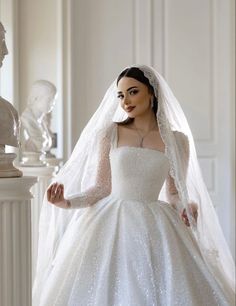 a woman wearing a wedding dress and veil