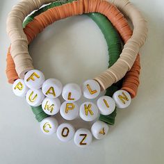 a close up of a bracelet made out of plastic beads with words written on it